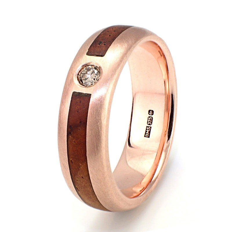 9ct rose gold engagement ring with an inlay of cocobolo wood meeting at an ethical diamond | 5mm wide | by Eco Wood Rings
