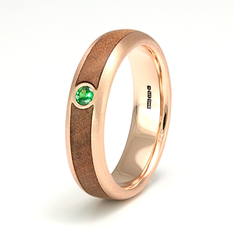 Rounded edge 9ct rose gold engagement ring with a sycamore wood inlay meeting at a green tsavorite garnet | by Eco Wood Rings