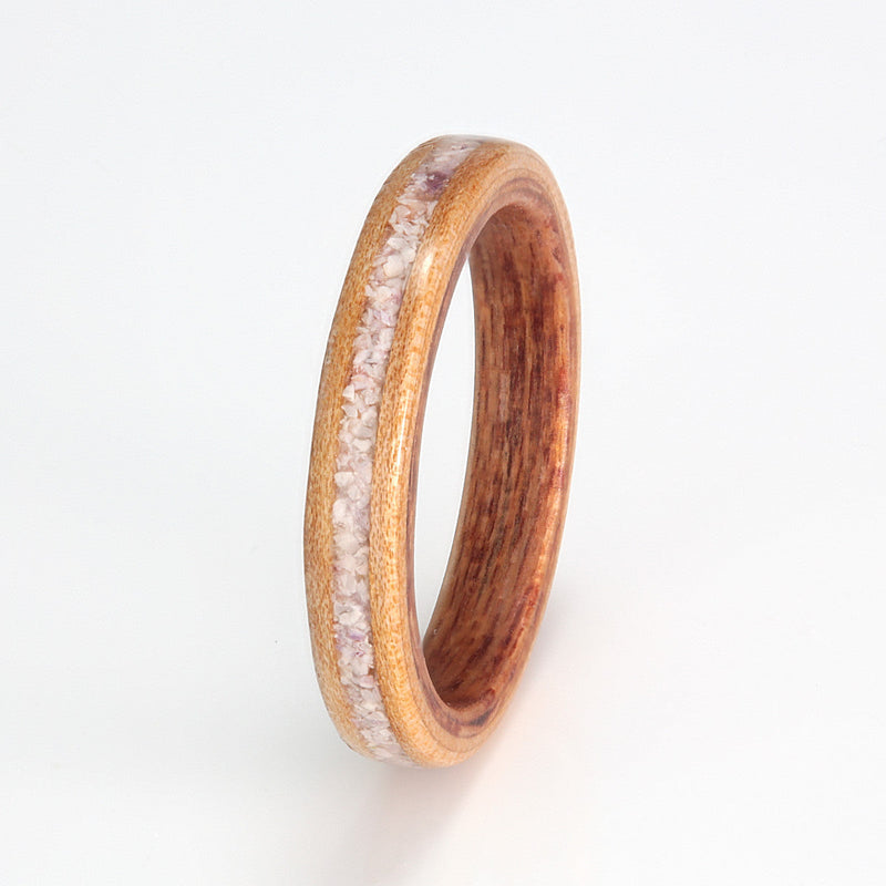 Apple wood ring with a keruing wood liner and a centred inlay of mixed amethyst and shell | by Eco Wood Rings