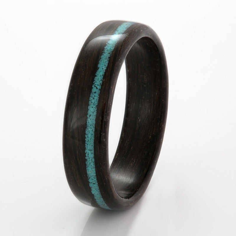 Alternative wedding ring made from bogwood | 6mm wide with 1mm off centre inlay of turquoise | by Eco Wood Rings