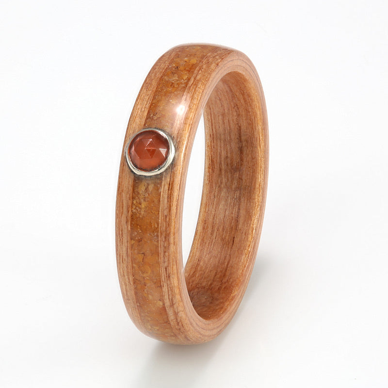 Ethical engagement ring | Cherry wood ring with customer provided pebble inlay meeting at a round orange carnelian in bezel