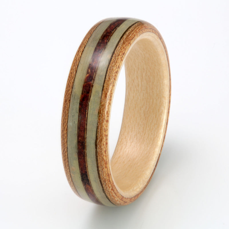 Chestnut bentwood ring with a maple liner | Centred inlay of pine cone flanked by inlays of pine needle | by Eco Wood Rings