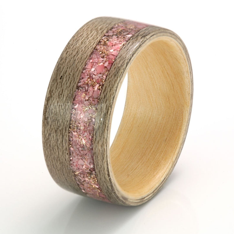 10mm wide greyed maple wedding ring with a magnolia liner and 4mm centred inlay of mixed petals, rose gold shavings and agate