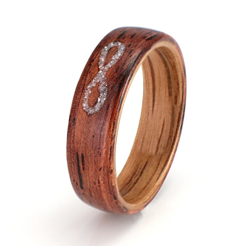 Infinity Ring | Honduras rosewood ring with an oak liner and an infinity symbol inlay in mother of pearl | by Eco Wood Rings