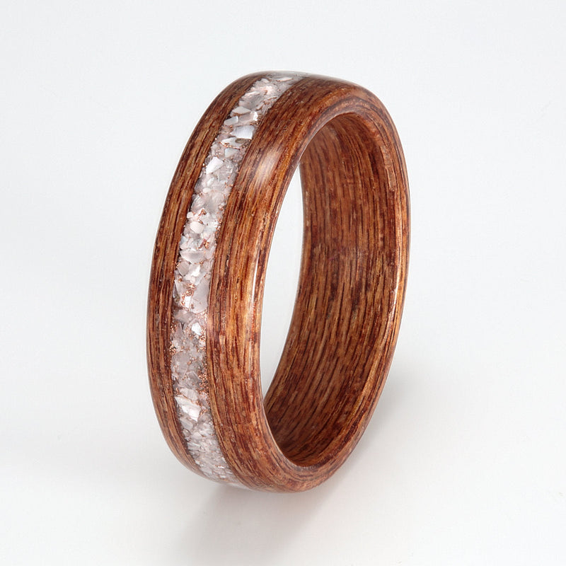 Ethical wedding ring made from reclaimed Keruing wood with a centred inlay of mixed mother of pearl and rose gold shavings